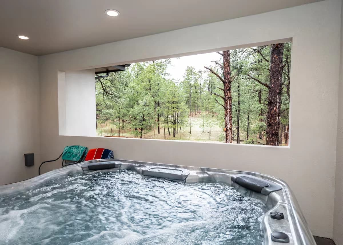 Private hot tub on the covered upper patio of the Black Forest guest house, looking into the ponderosa pines