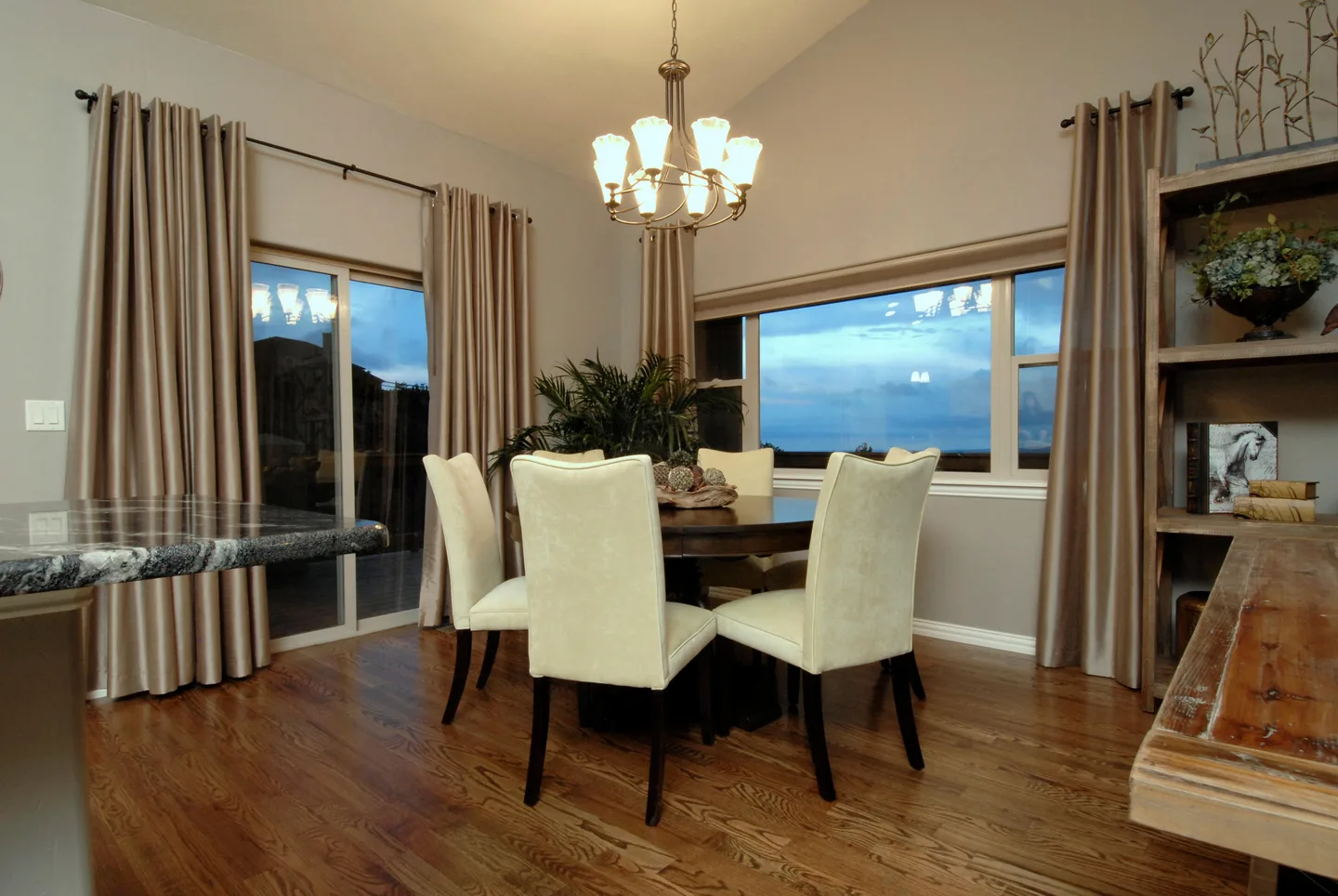 Dining room with chandelier, hardwood floors and picture windows overlooking the Front Range.