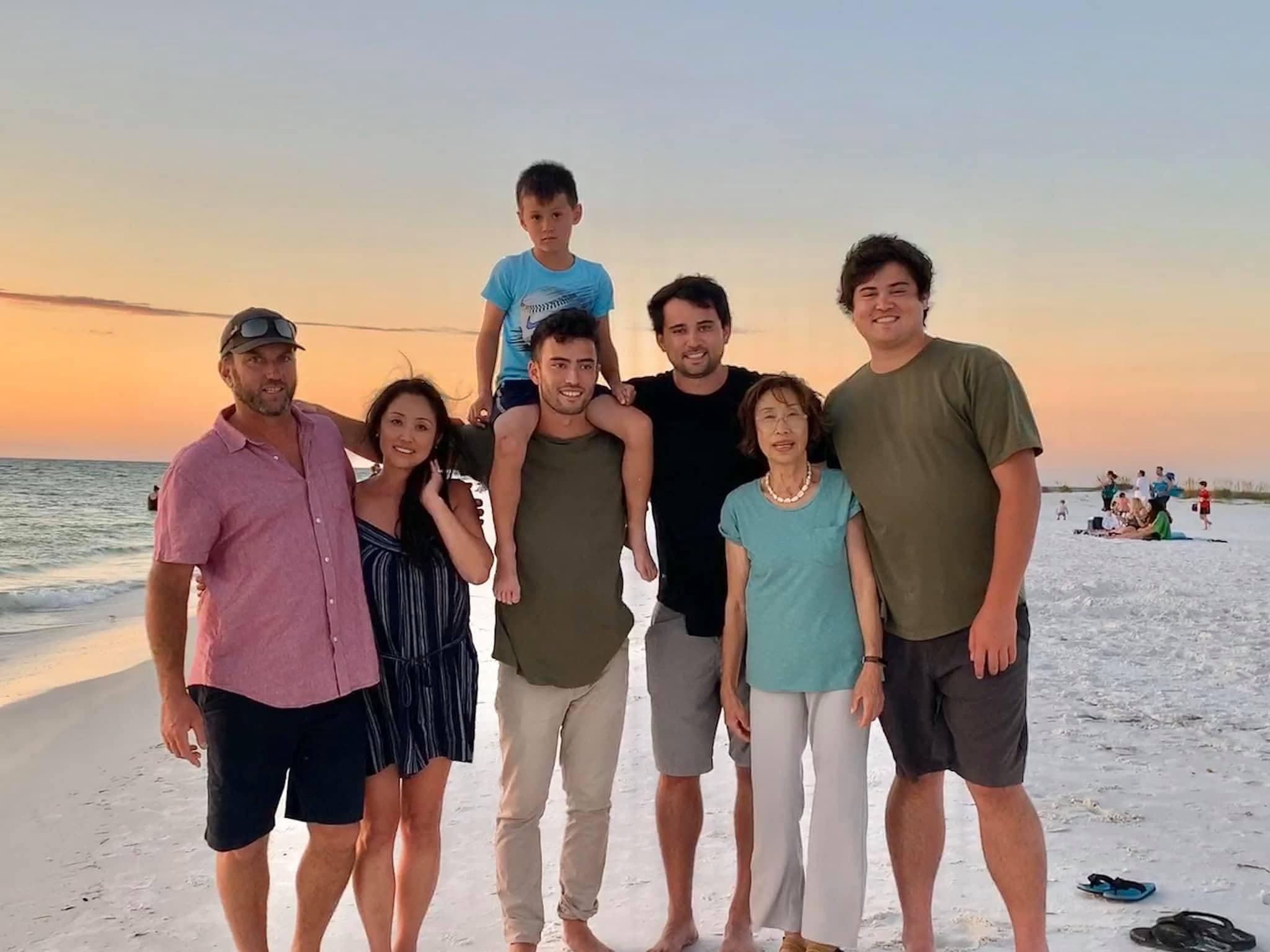 The Stauffer family together on the beach at sunset